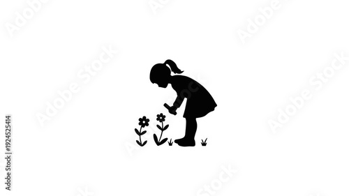 Silhouette of a young girl observing flowers in a garden.