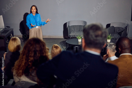Woman speaks at a forum