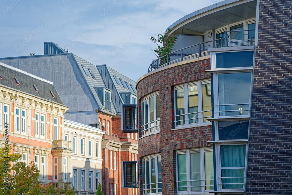 Fototapeta premium Curved building facade with box like attachments where pigeons perch.