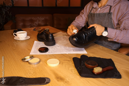 Male shoemaker polishing sh...