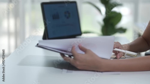 Businesswoman working on financial report with tablet