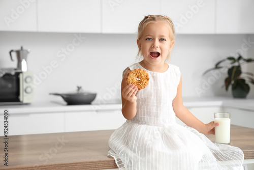 Cute little girl eating tas...