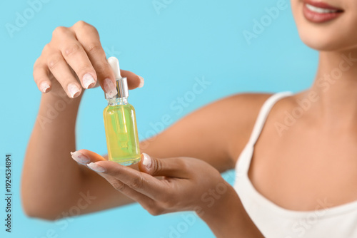 Young woman holding serum w...