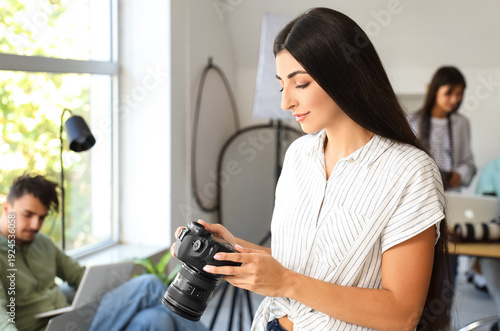 Female photographer with ca...