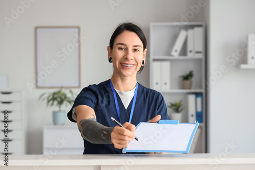 Tattooed female doctor with...
