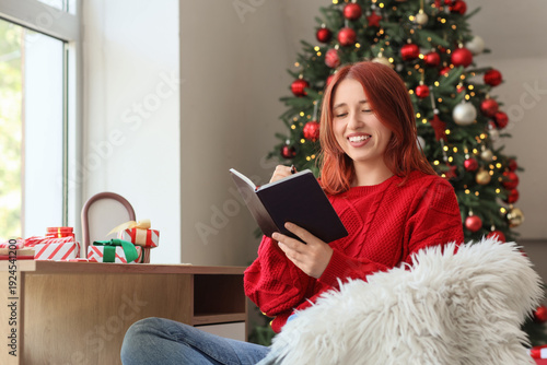 Young woman writing New Yea...