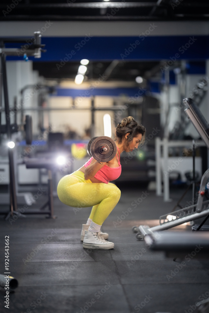 Fototapeta premium Woman doing barbell squats for leg training