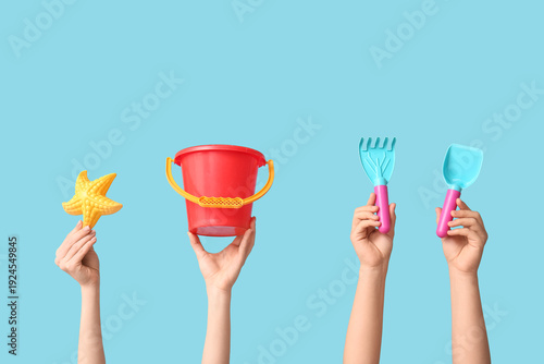 Hands holding baby toys on ...