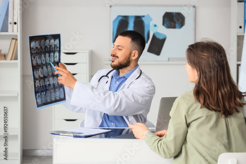 Male doctor showing MRI sca...