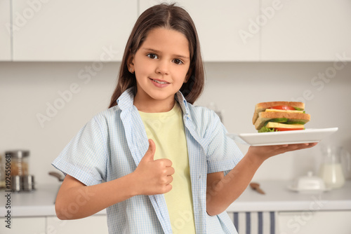 Cute girl with tasty sandwi...