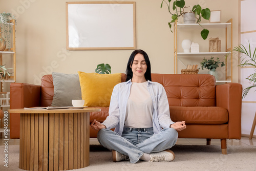 Young woman meditating on c...