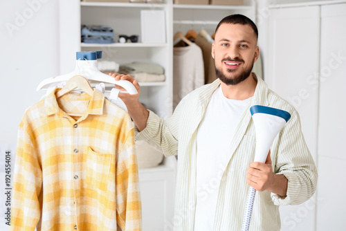 Young man with steamer and ...