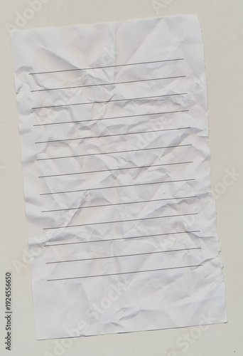 Wide Ruled notebook paper that has been crumpled and flattened with ripped edge