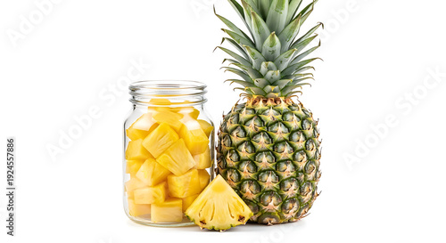 A pineapple and a jar of pineapple chunks on a white background