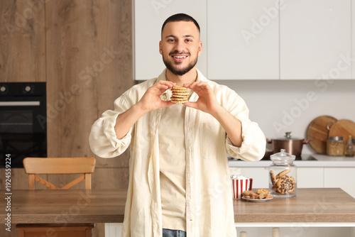 Young man with cookies in k...