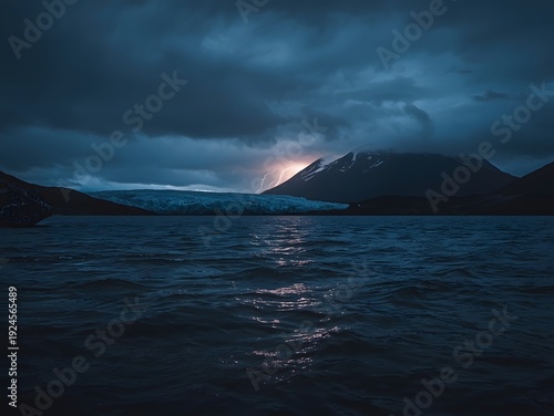 A beautiful sunset glows over a vast blue ocean and rocky coastal mountains where nature and clouds reflect in the serene island bay landscape