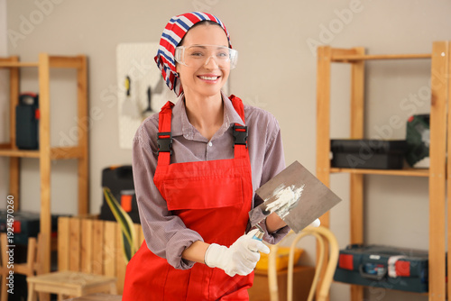 Female decorator with putty...