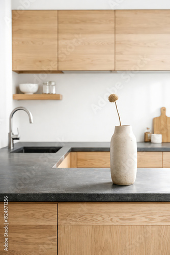 Minimalist wooden kitchen interior with stone countertop and vase