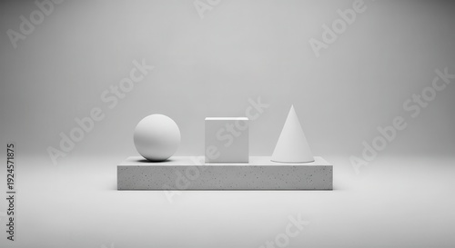 Three basic geometric solids are arranged on a textured pedestal within a minimalist  setting.