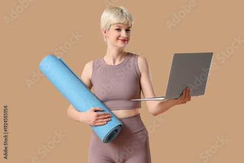 Sporty young woman with yog...