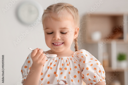 Cute little girl with spoon...