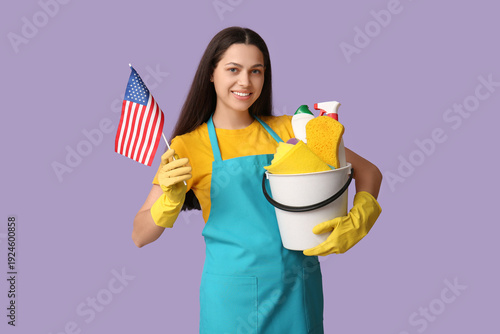 Female janitor holding buck...