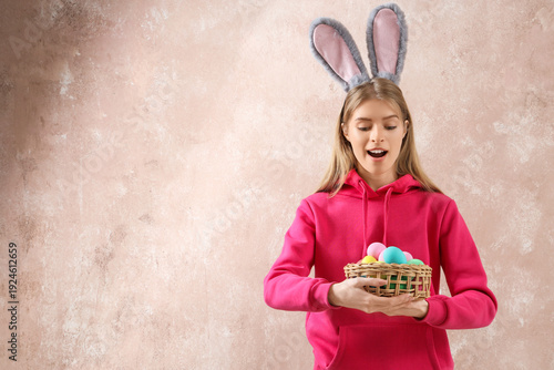 Young woman in bunny ears w...