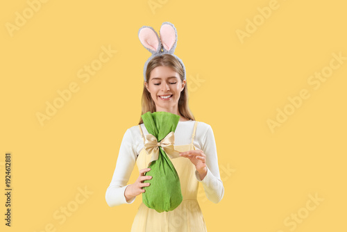 Young woman in bunny ears w...