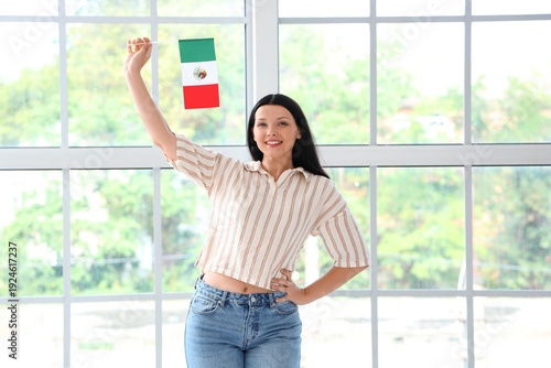 Free Download Young woman with Mexican flag near window at home - GFXLoad