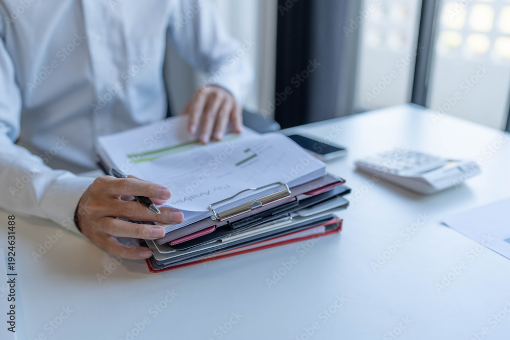 Fototapeta premium Businessman doing work reading documents
