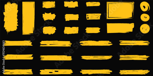 A collection of yellow brush strokes on a black background