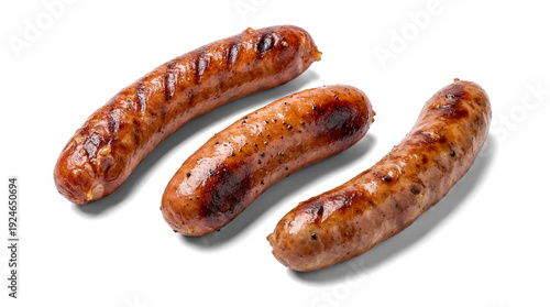 three perfectly grilled sausages, detailed with prominent grill marks and pepper seasoning, presented against a stark transparent background for dramatic food presentation.
