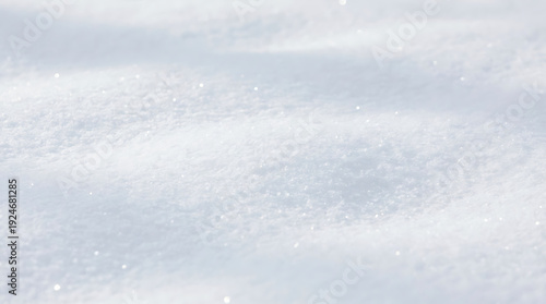 Snowflakes falling on snow-covered ground from aerial viewpoint