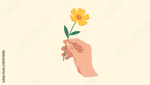 Person's hand holding a single yellow flower with a simple happy face drawn in the center against a pale cream background.