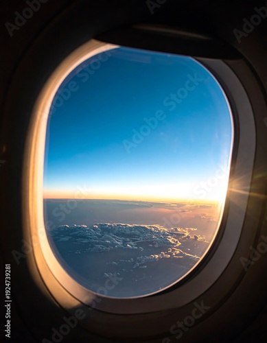 Soaring Views: A serene vista of the vast sky, clouds, and horizon is framed by the circular window of an airplane, offering a glimpse into the beauty of travel.