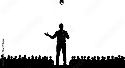 Silhouette of a man speaking to a large audience