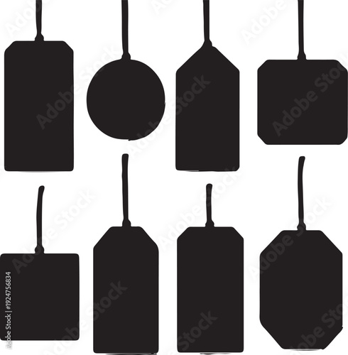 Collection of various black price tags and labels in different shapes and orientations, hanging by strings