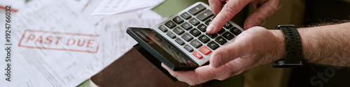Tableau sur toile Senior Caucasian man using calculator while reviewing overdue bills, hands holdi