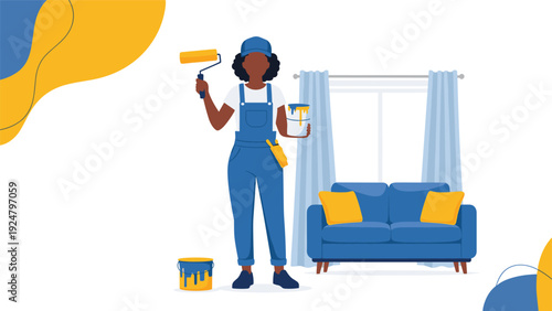 Professional female house painter in overalls holding a roller and paint bucket standing in a living room interior.