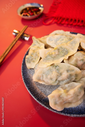 Принти на полотні Asian Dumplings with Chopsticks on Red Background