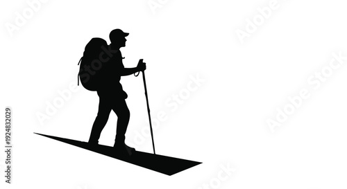 Silhouette of a hiker with a backpack and trekking poles on a snowy slope