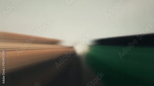 Fast motion blur effect over blurred landscape during daytime