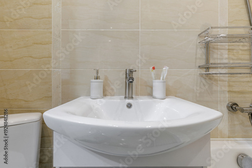 Modern Bathroom Sink with Soap Dispenser and Toothbrushes