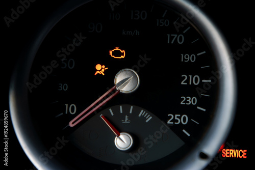 Car dashboard illuminating engine and airbag warning lights, indicating a vehicle malfunction and requiring immediate service for diagnosis and repair