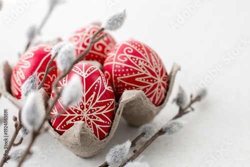 Photos Red traditional hand written Easter eggs with catkin