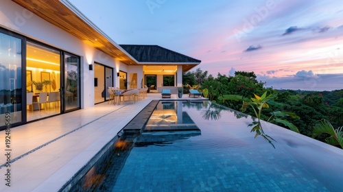 Wallpaper Mural Elegant Villa with Infinity Pool Surrounded by Lush Greenery Under Colorful Twilight Sky Torontodigital.ca