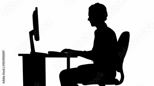 Businessman working diligently on computer in office