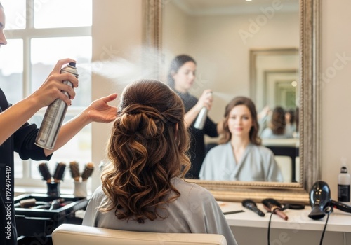 A beautiful girl in a beauty salon gets a chic hairstyle. Sprays with hairspray