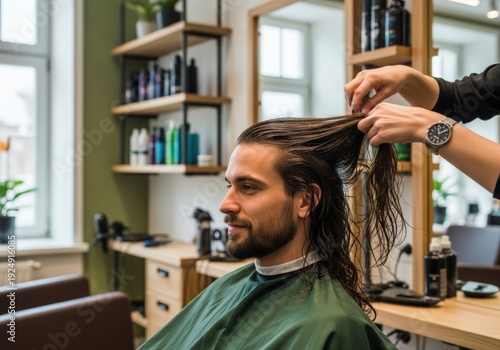 A man with long, flowing hair receiving a conditioning treatment and trim in a unisex salon. Breaking gender stereotypes, focus on hair health and individuality.