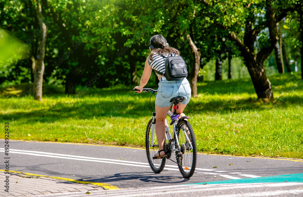 Naklejka premium Cyclist ride on the bike path in the city Park 